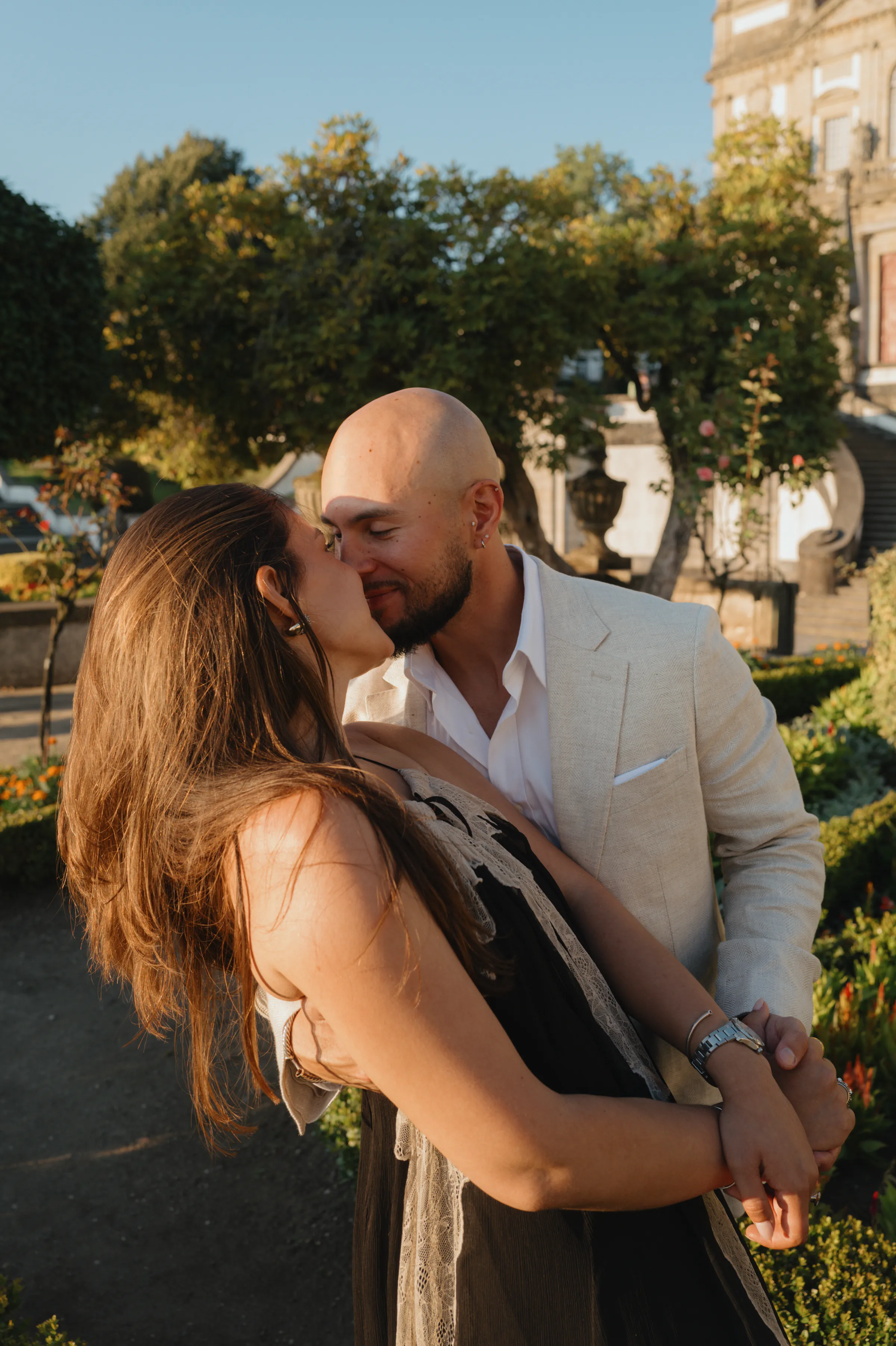 Couple close portrait during an outdoor city garden session in warm soft light.